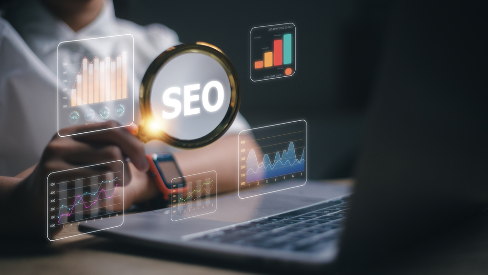 Women use magnifying glasses and computers for analysis of SEO,